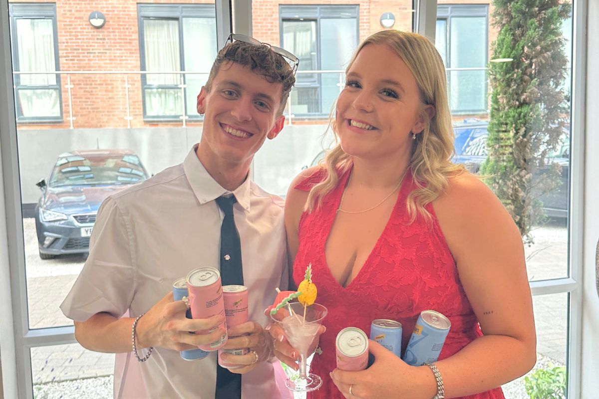 Two tenants holding their drinks and smiling together