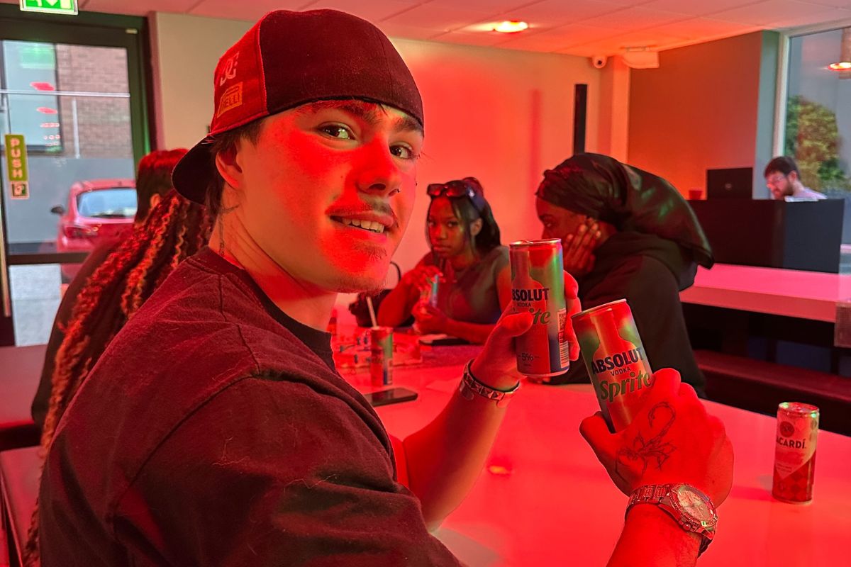 a student holding up drinks at the welcome social