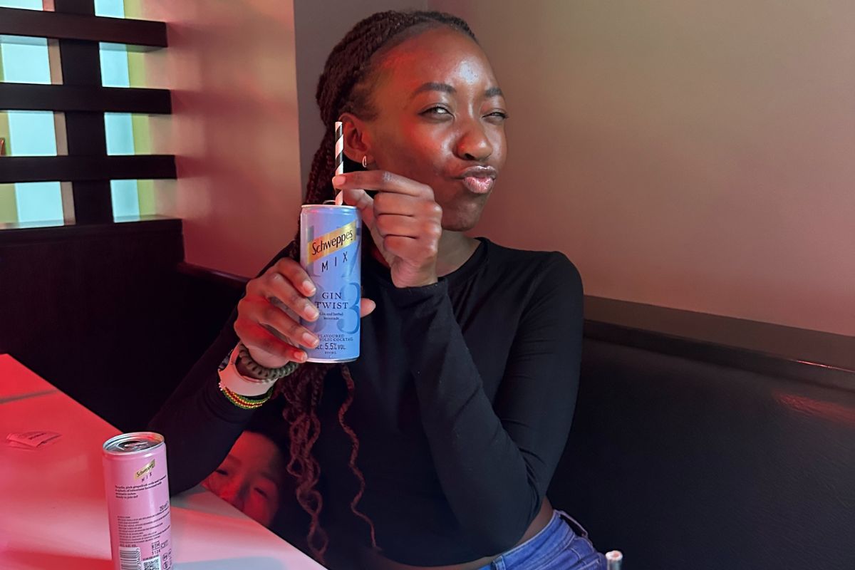 a girl holding up her drink