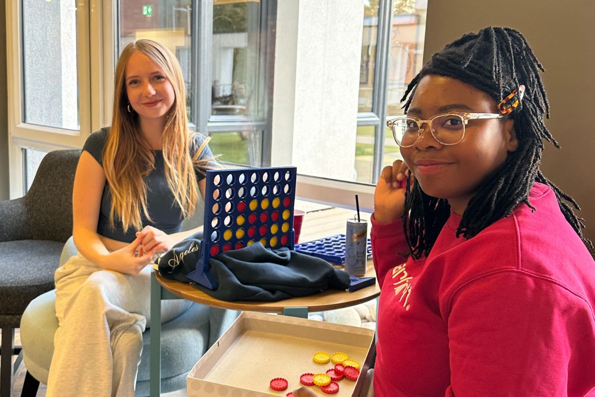 Two girls playing games at the welcome event