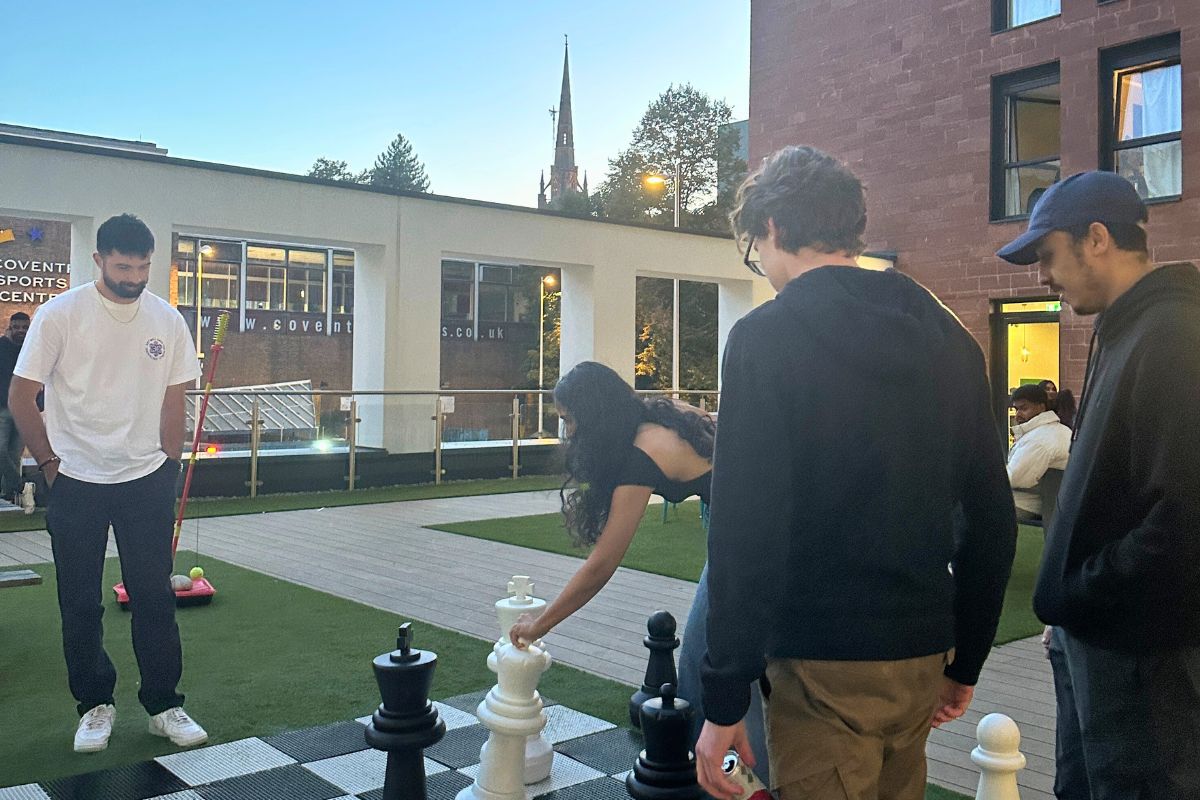 a group of friends playing chess on the CODE terrasse