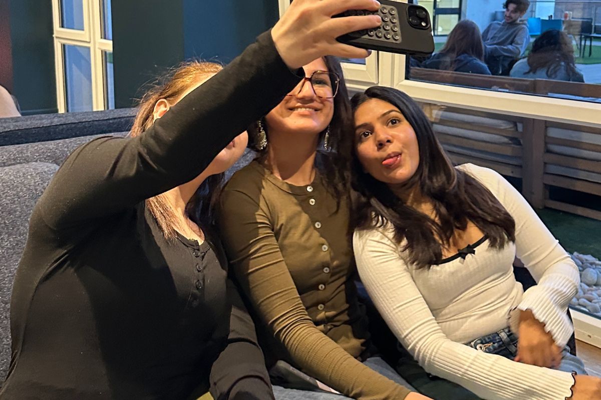 three friends taking a selfie on the sofa