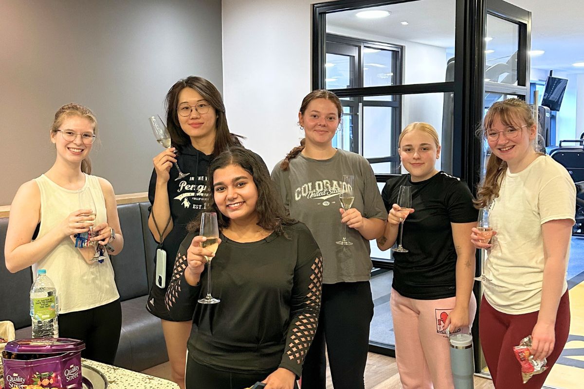 a group of friends attending the class cheering after the workout!