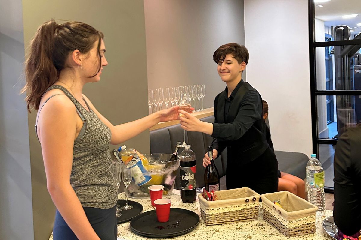 CODE staff handing prosecco to the attendees