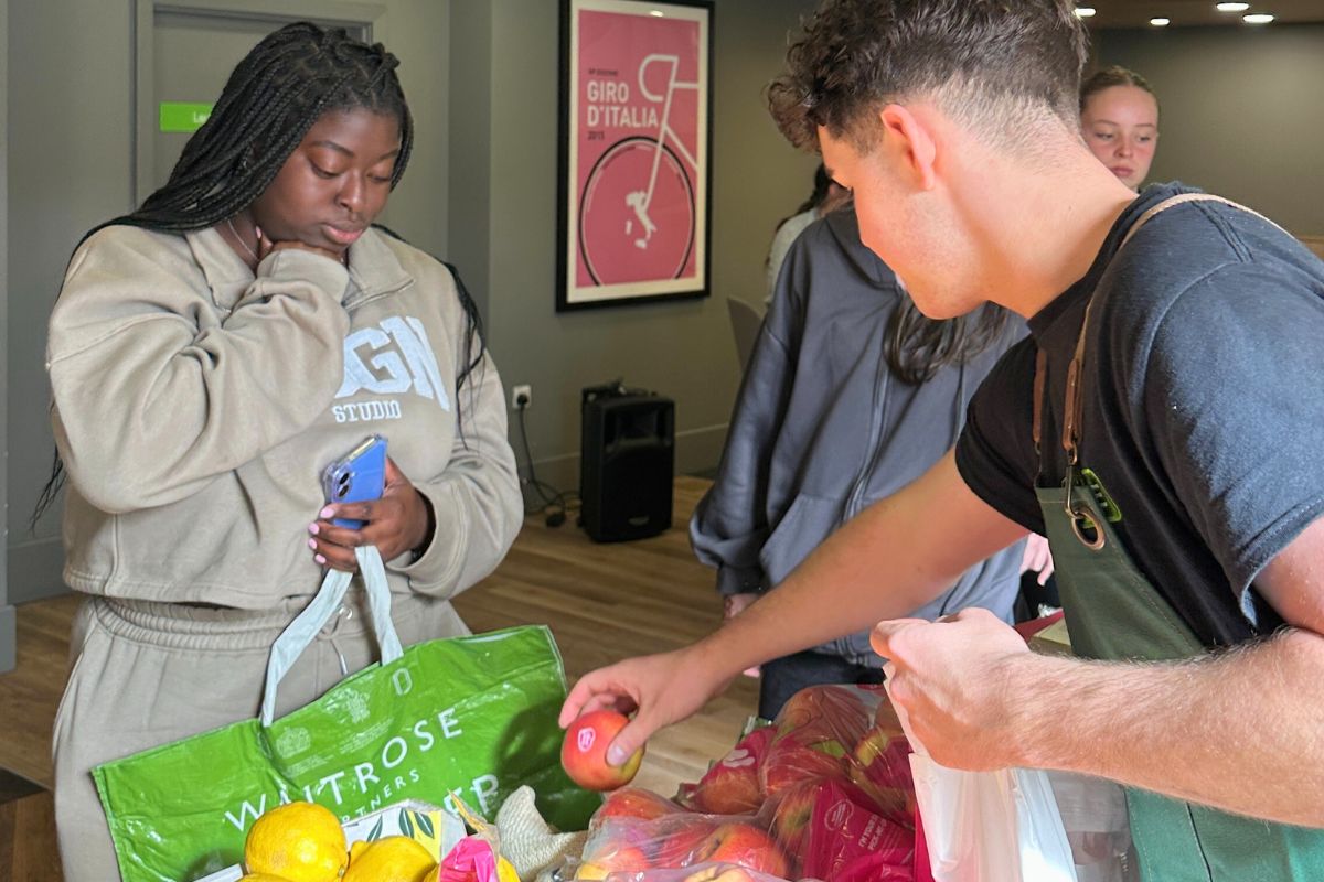 Student deciding what she wants from the fruit and veg event