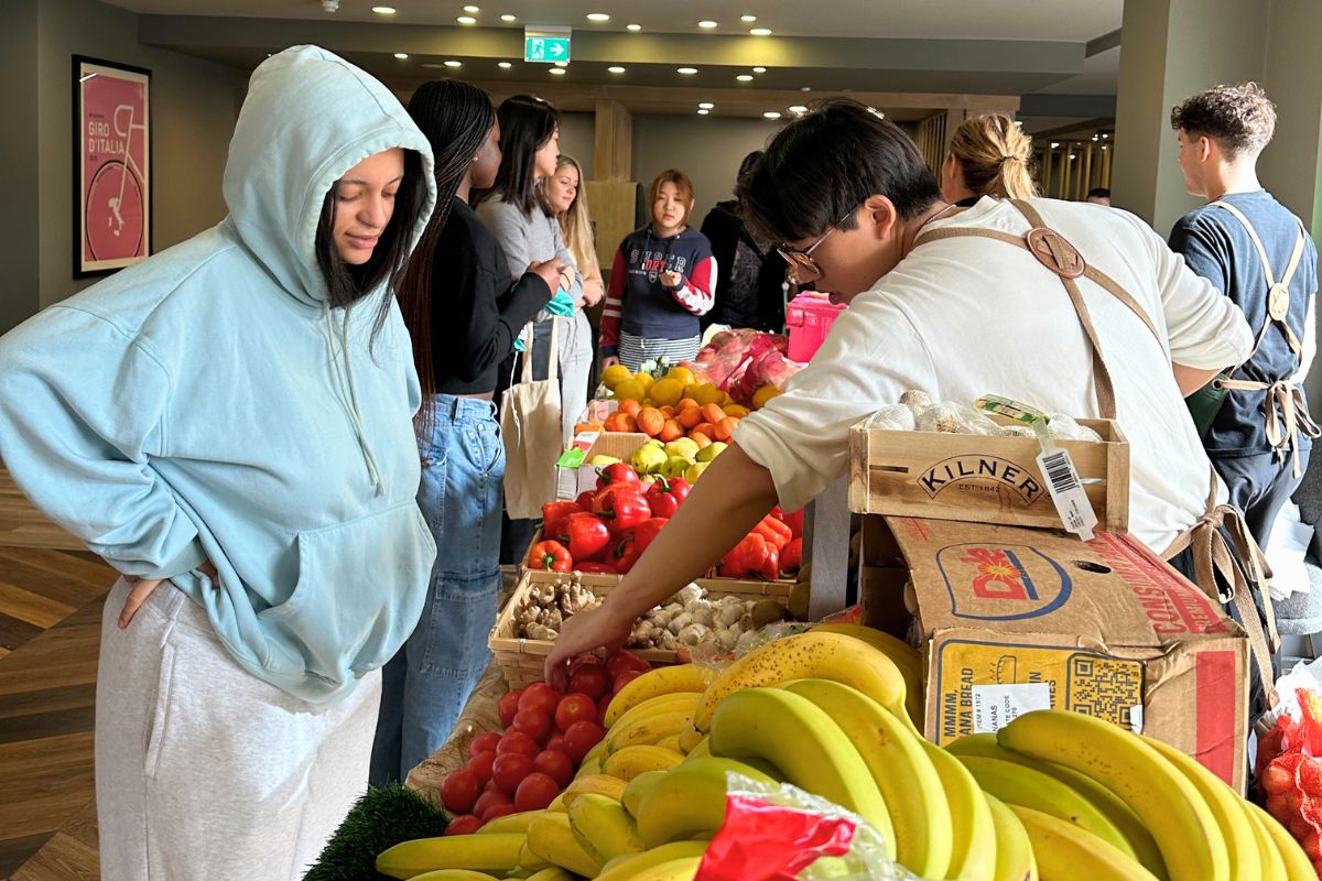 Student picking what they want from the fruit and veg giveaway at CODE