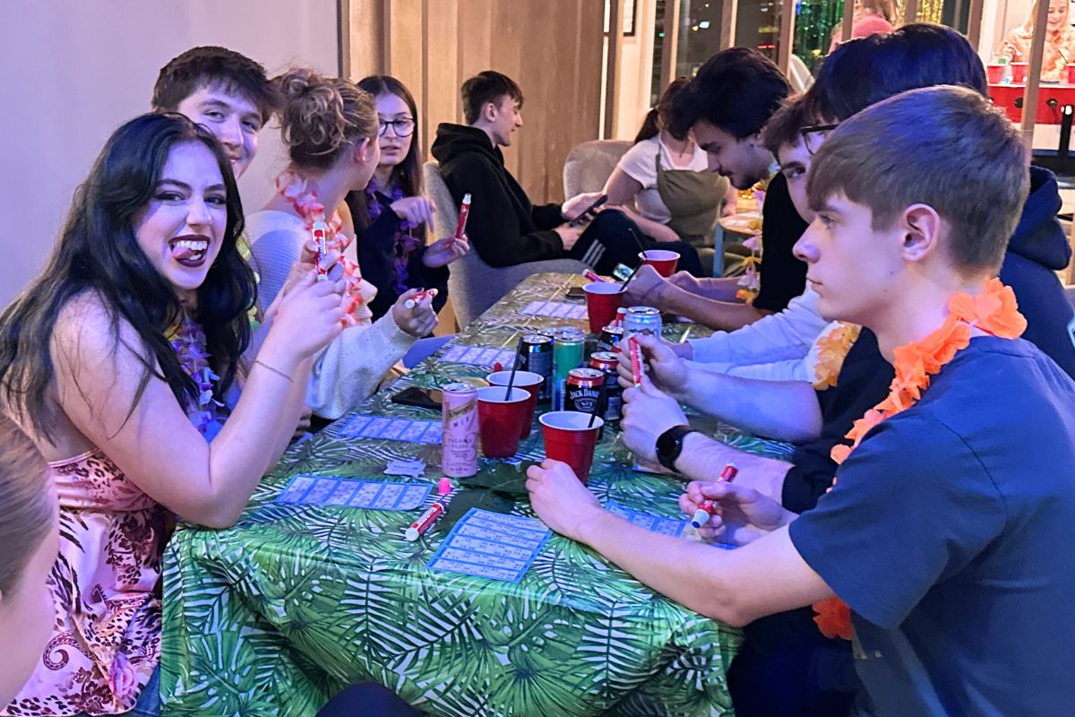Tenants sitting around a table playing bingo together