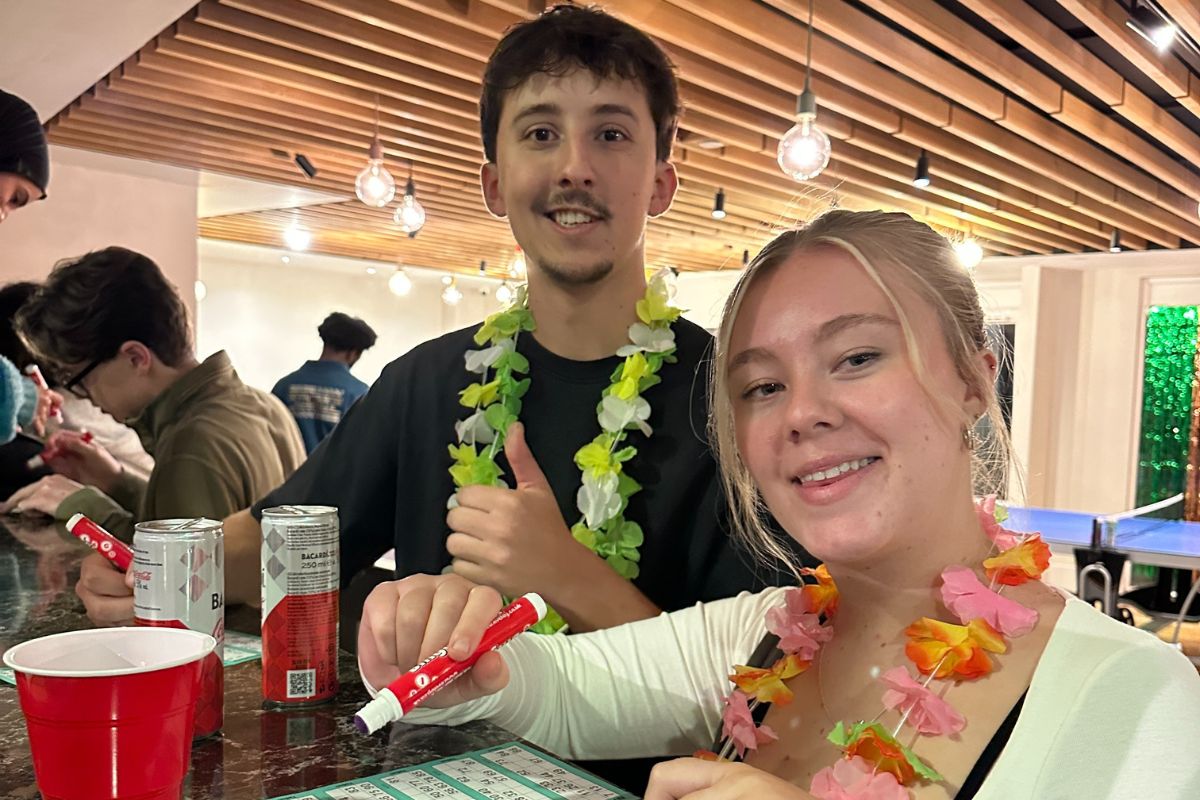 two friends with their drinks playing bingo