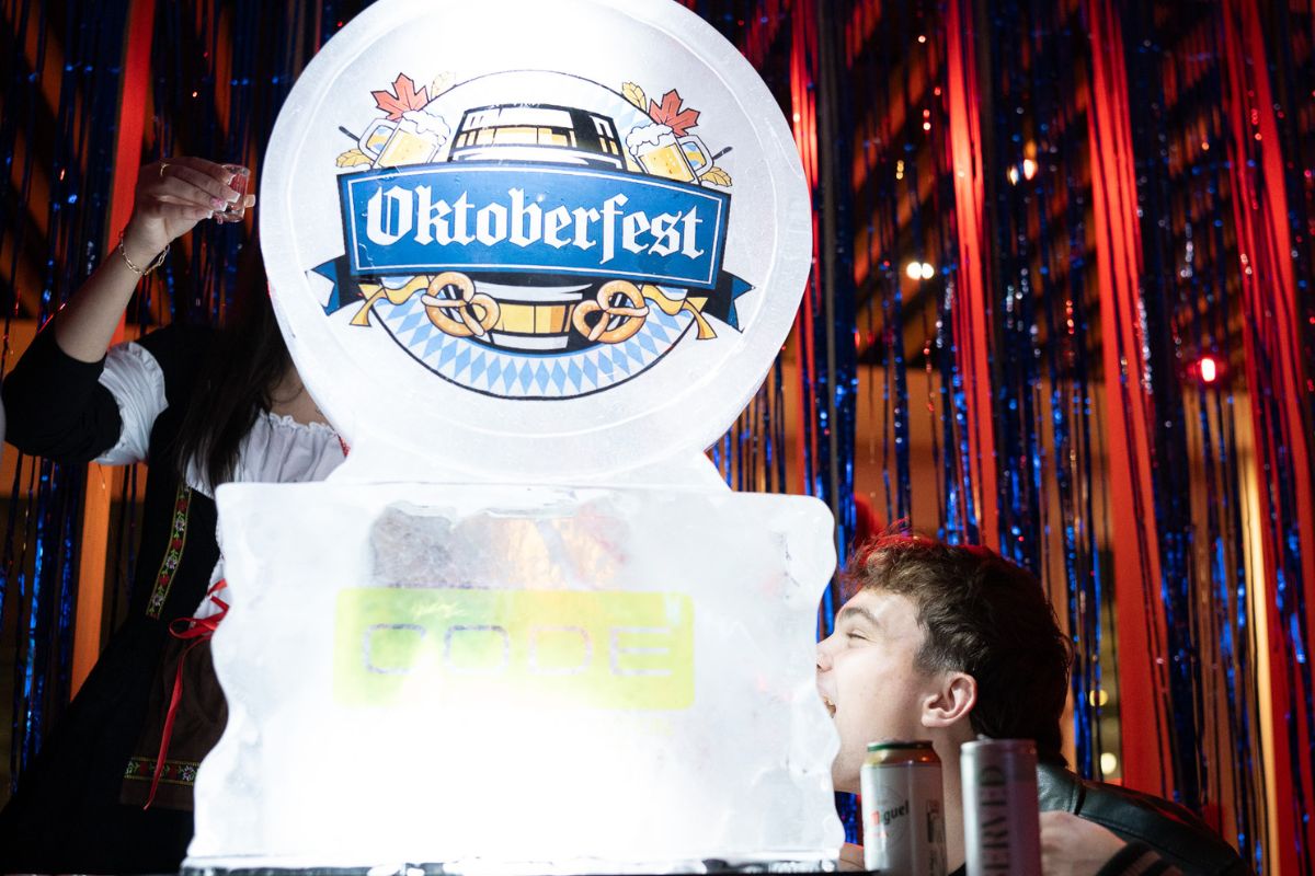 Student drinking from an Oktoberfest ice sculpture