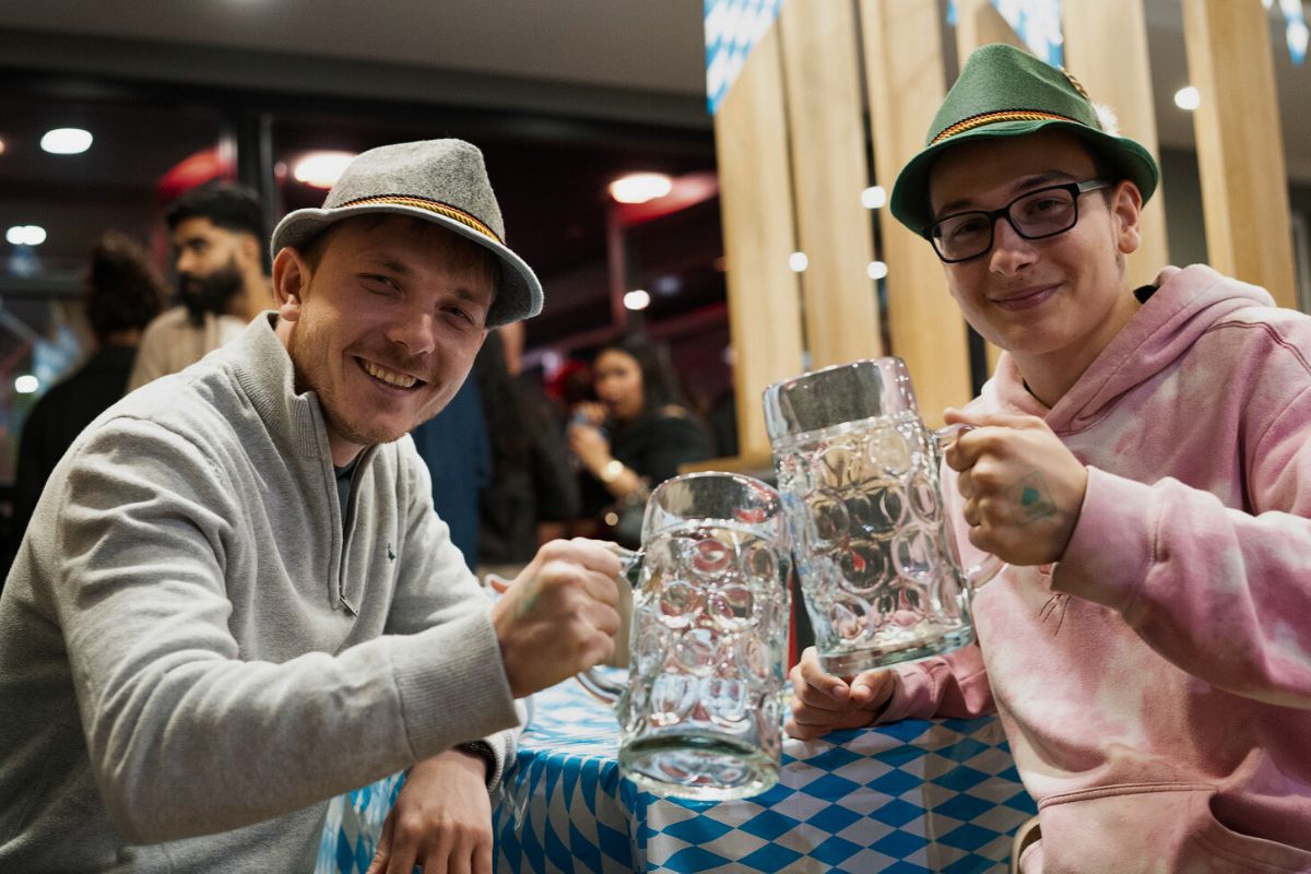 Two friends toasting their steins