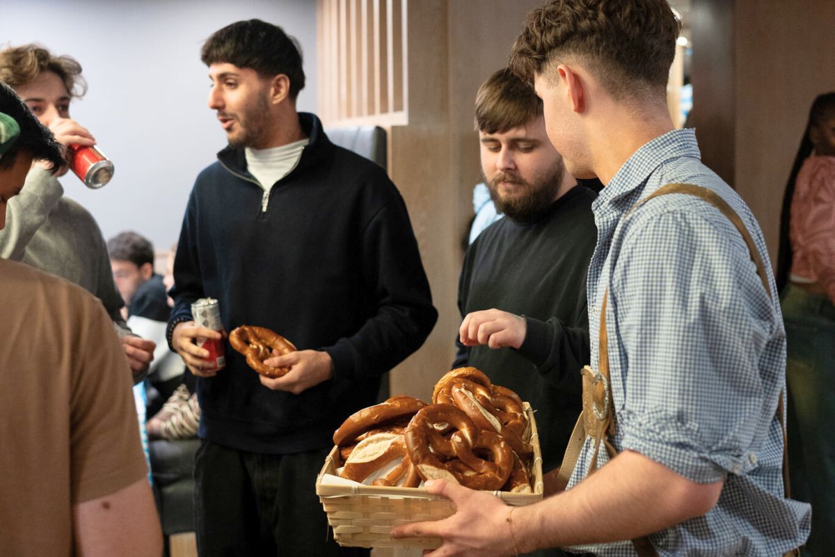 Staff member holding a basket of giant pretzels