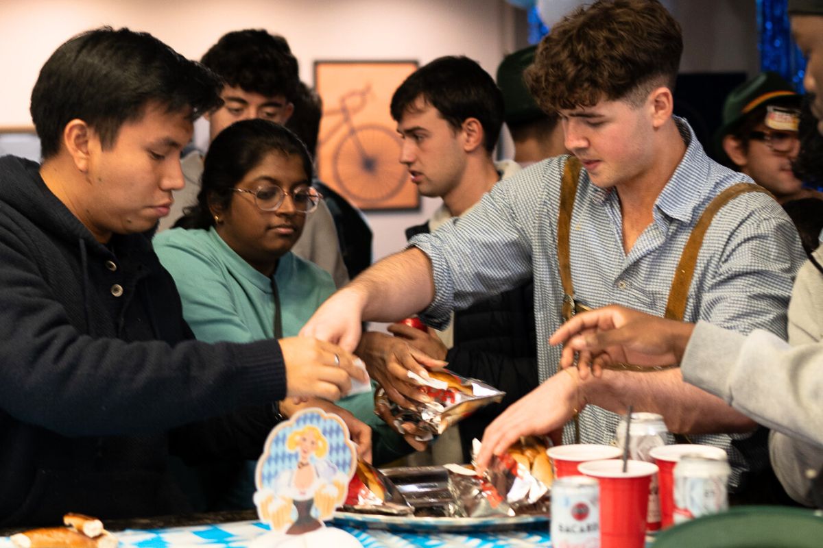 Student receives a hotdog at the party