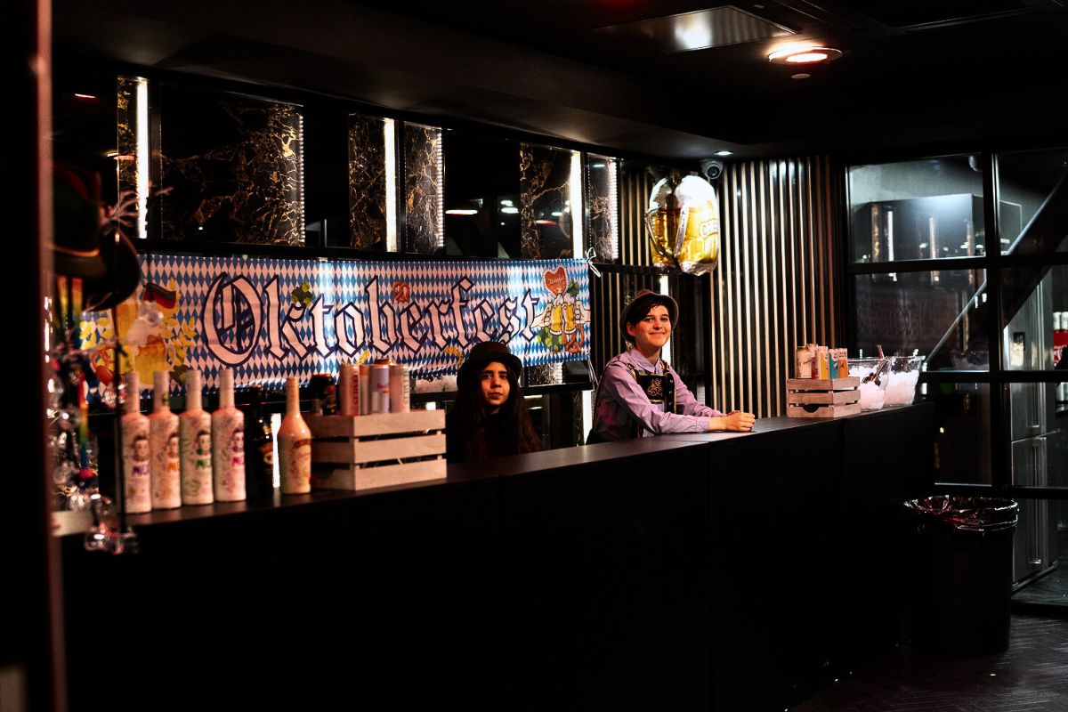 Staff smile at the neatly stocked bar