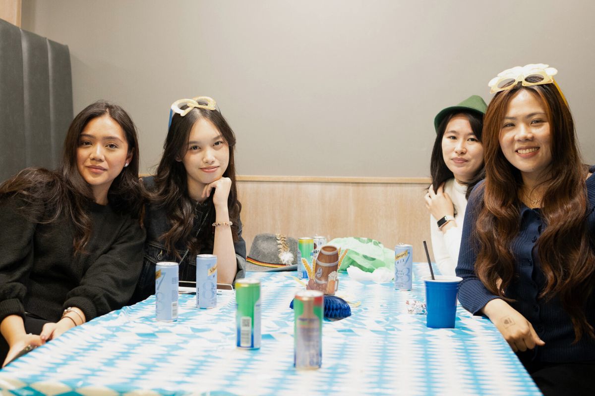 Four friends smile warmly to the camera