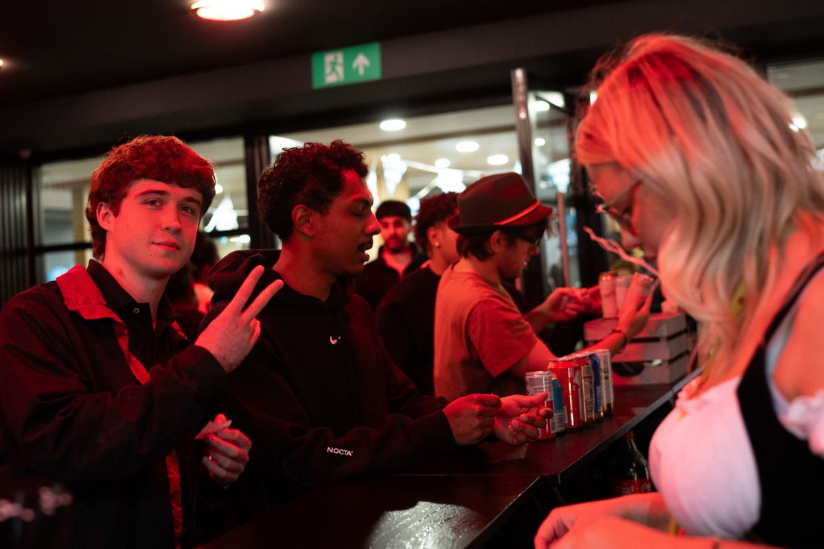 Tenant poses whilst queuing for a drink