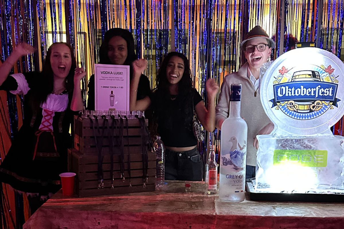 Students cheer at the vodka luge table