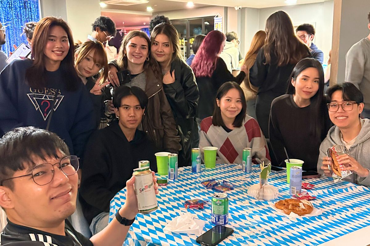 Student smiling with drinks and snacks