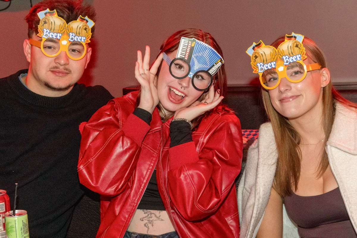 CODE student tenants wearing beer glasses at Oktoberfest