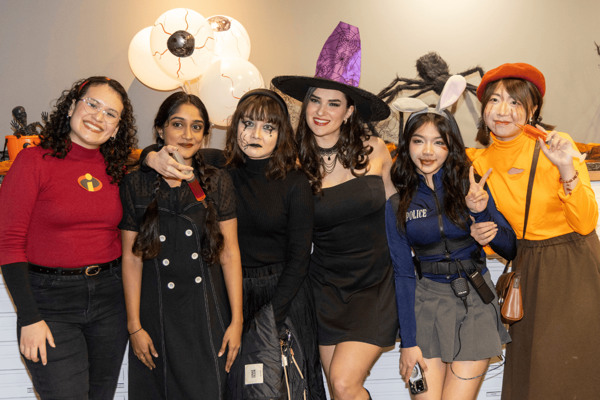 Halloween Bingo at CODE, a group of students that are dressed up are posing in front of the camera