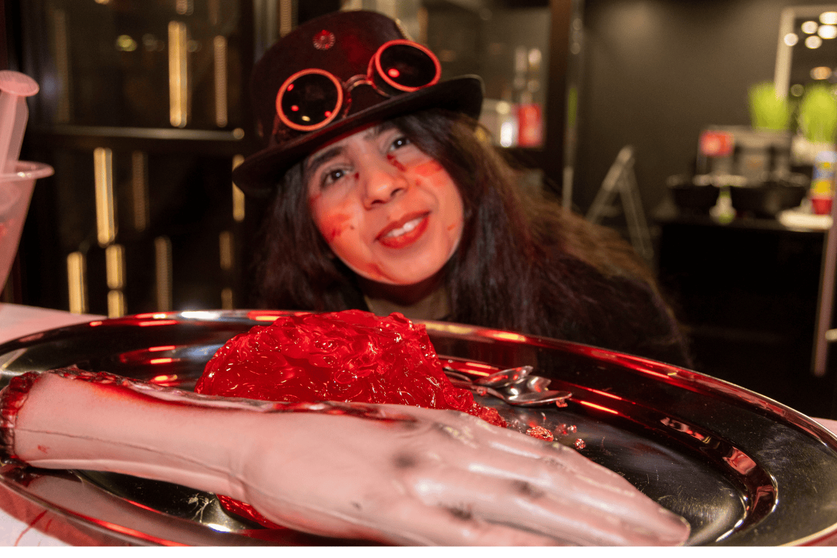 A CODE student posing behind some scary decor