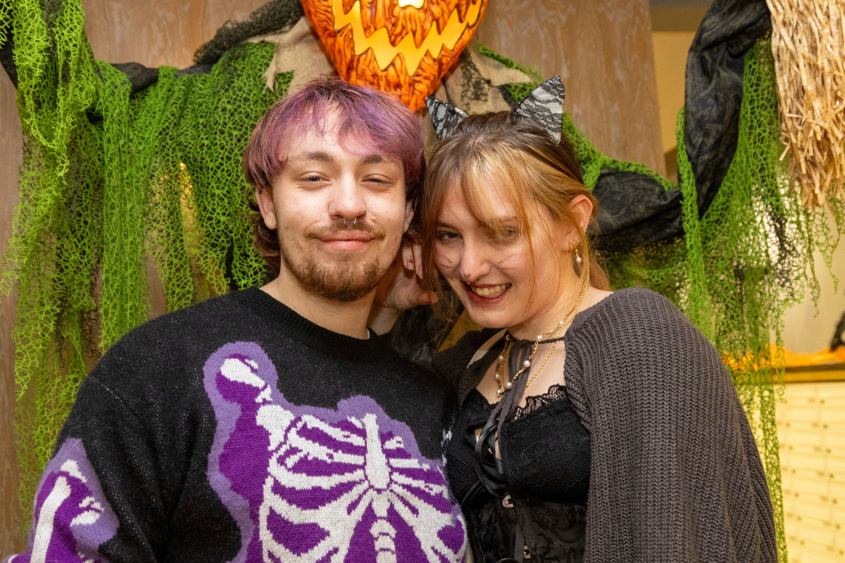 Students posing in front of the pumpkin man at the CODE bingo