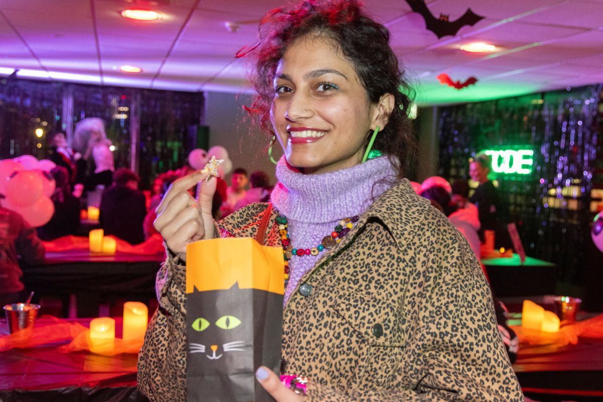 A CODE tenant holding a sweets bag