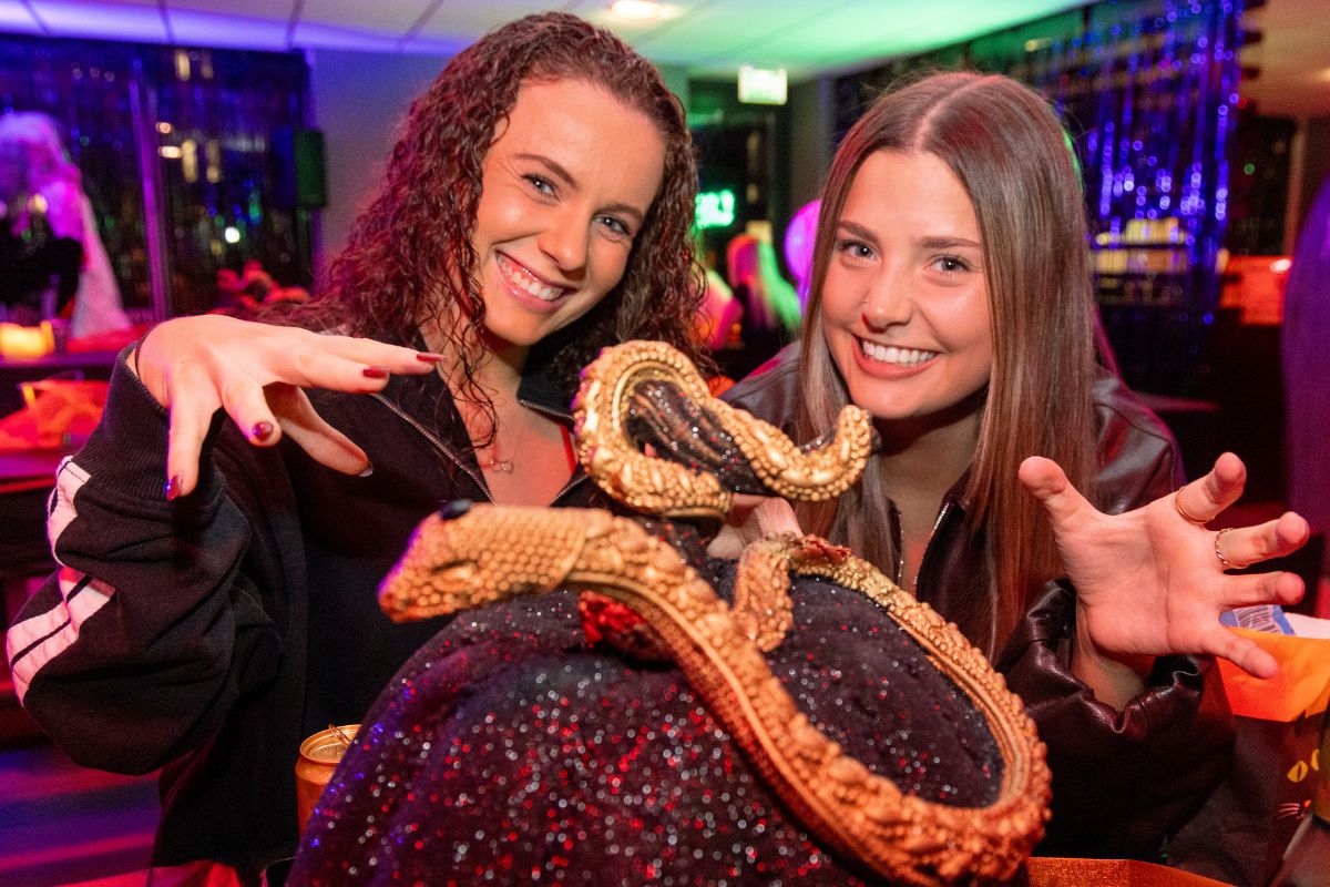 CODE students posing with the halloween decor