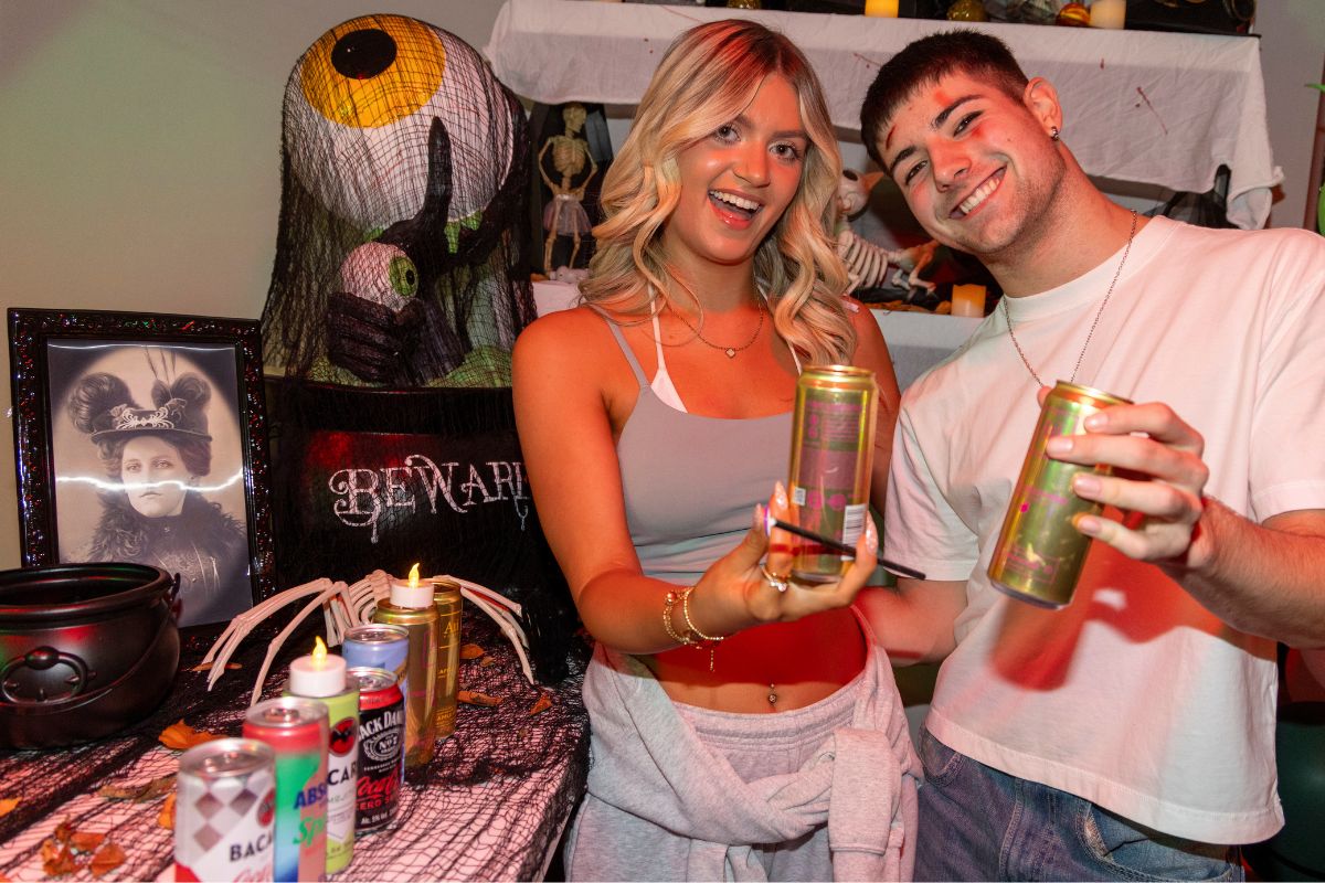 Two CODE students holding up their drinks