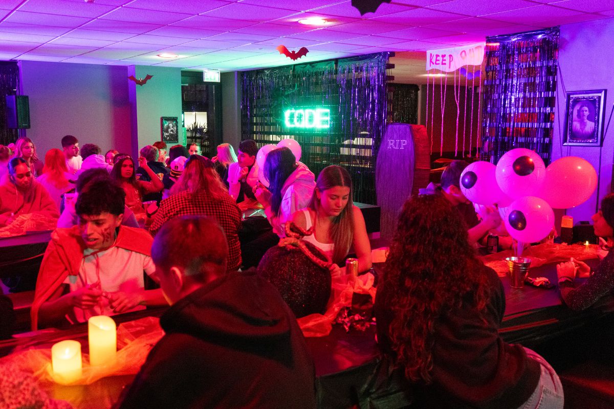 The communal area at CODE filled with students for the halloween bingo