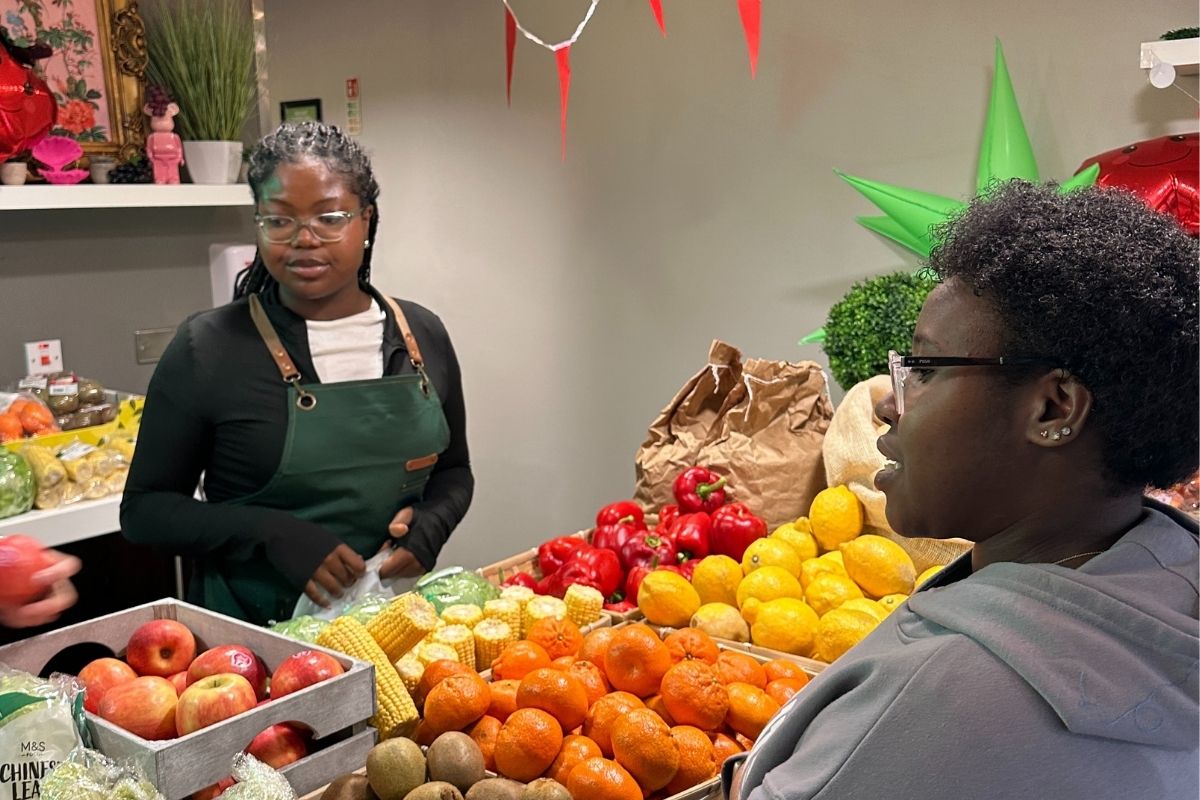 A CODE student grabbing some free fruit and veg