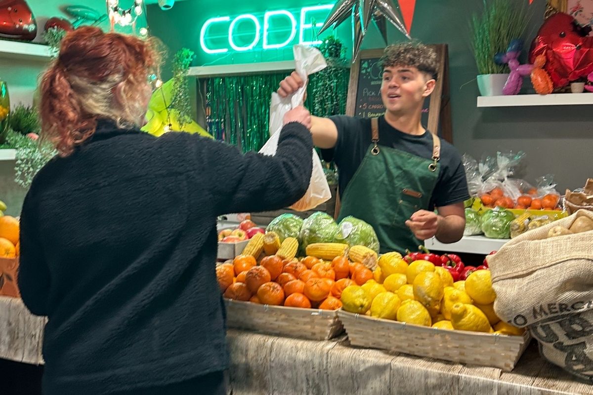 A CODE students picking their fruit and veg that they can grab for free