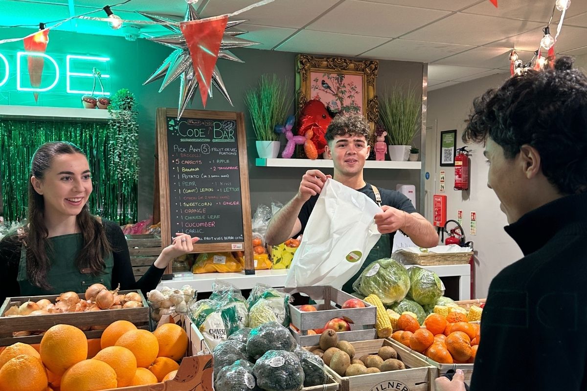 CODE Student ambassadors working behind the bar at the fruit and veg event