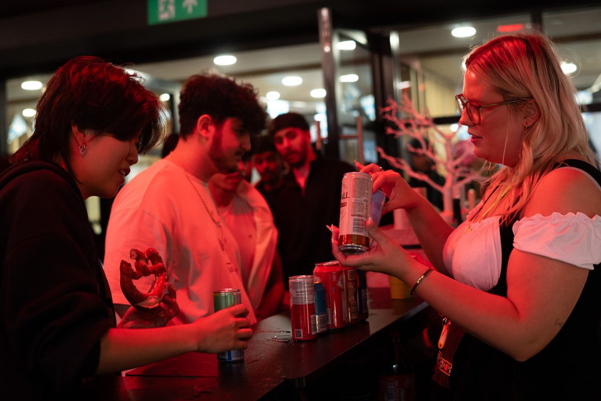 Staff shows student drinks available at the party