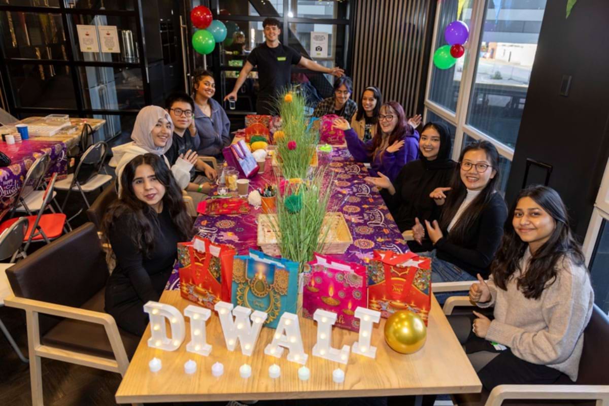 Students sat around table to celebrate Diwali