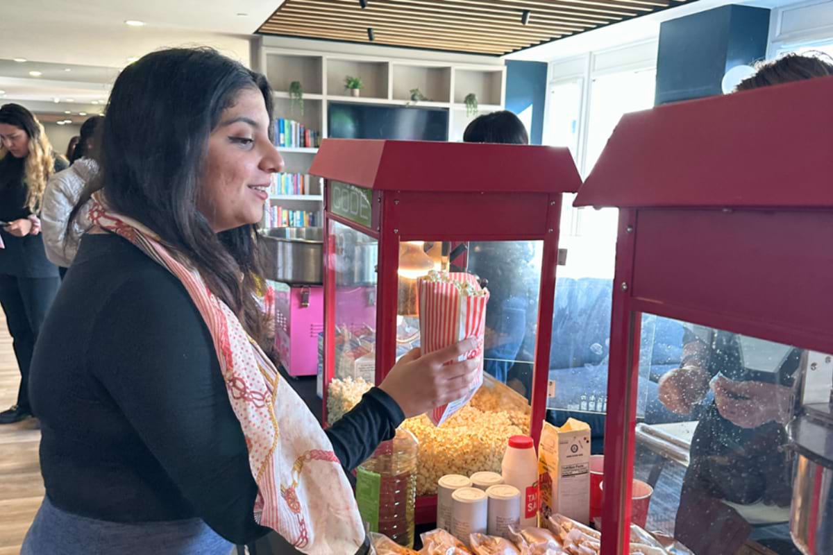 A woman getting her free popcorn