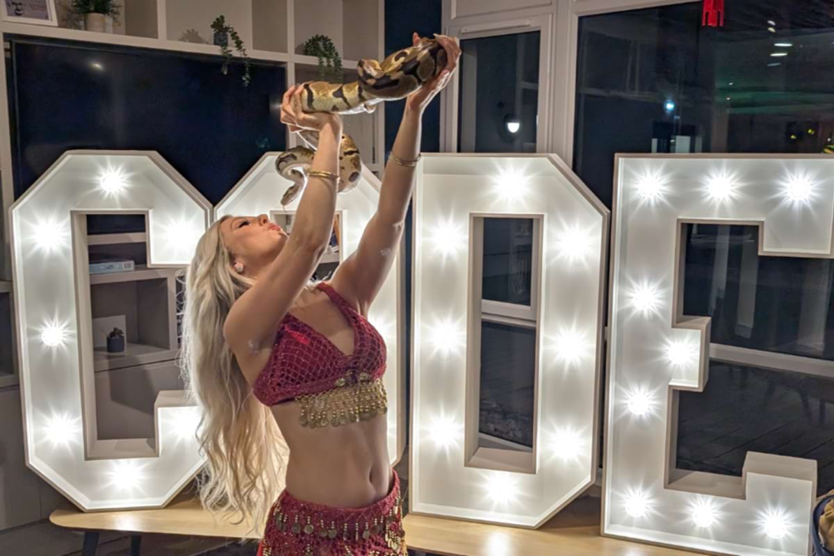 Live snake dancer posing with snake