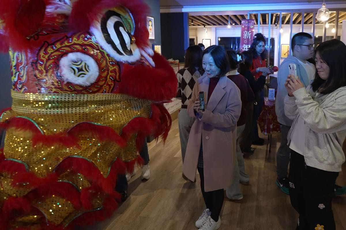 Two students creating a lion dancer at Lunar New Year