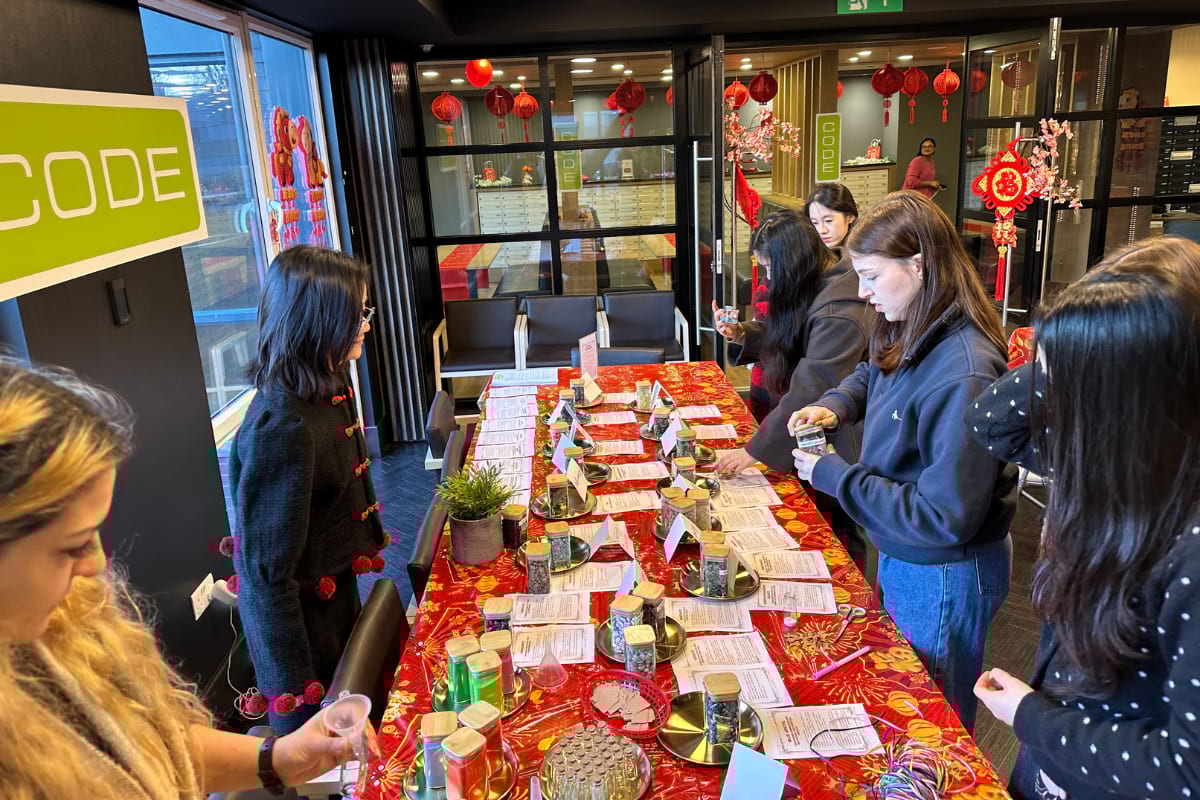 Students at a craft table putting crystals into jars