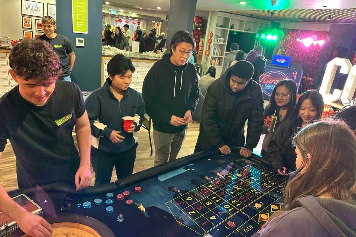 Students trying roulette with karaoke activities in the background