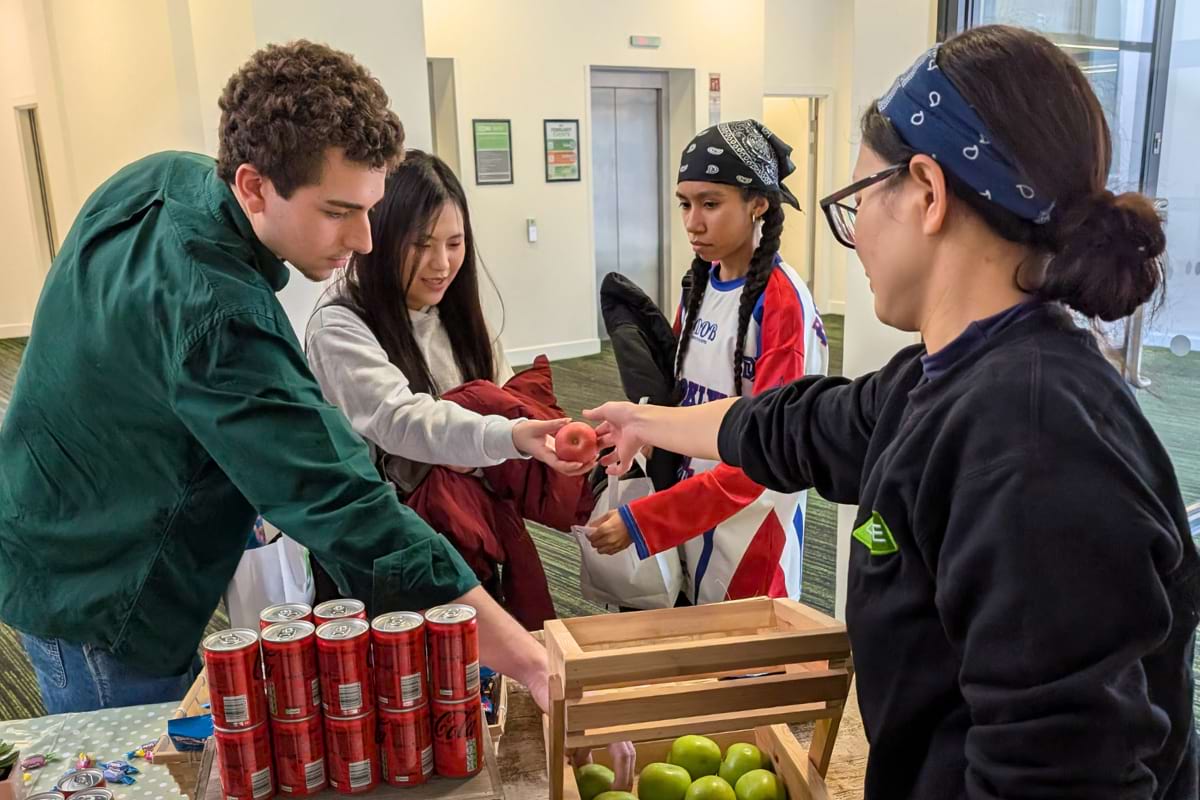 staff handing apple to tenant
