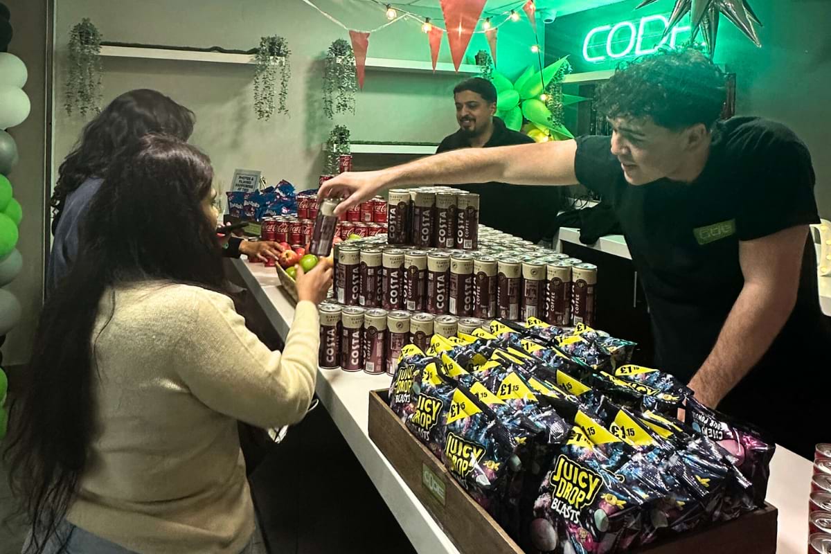 staff handing goody bags to tenant