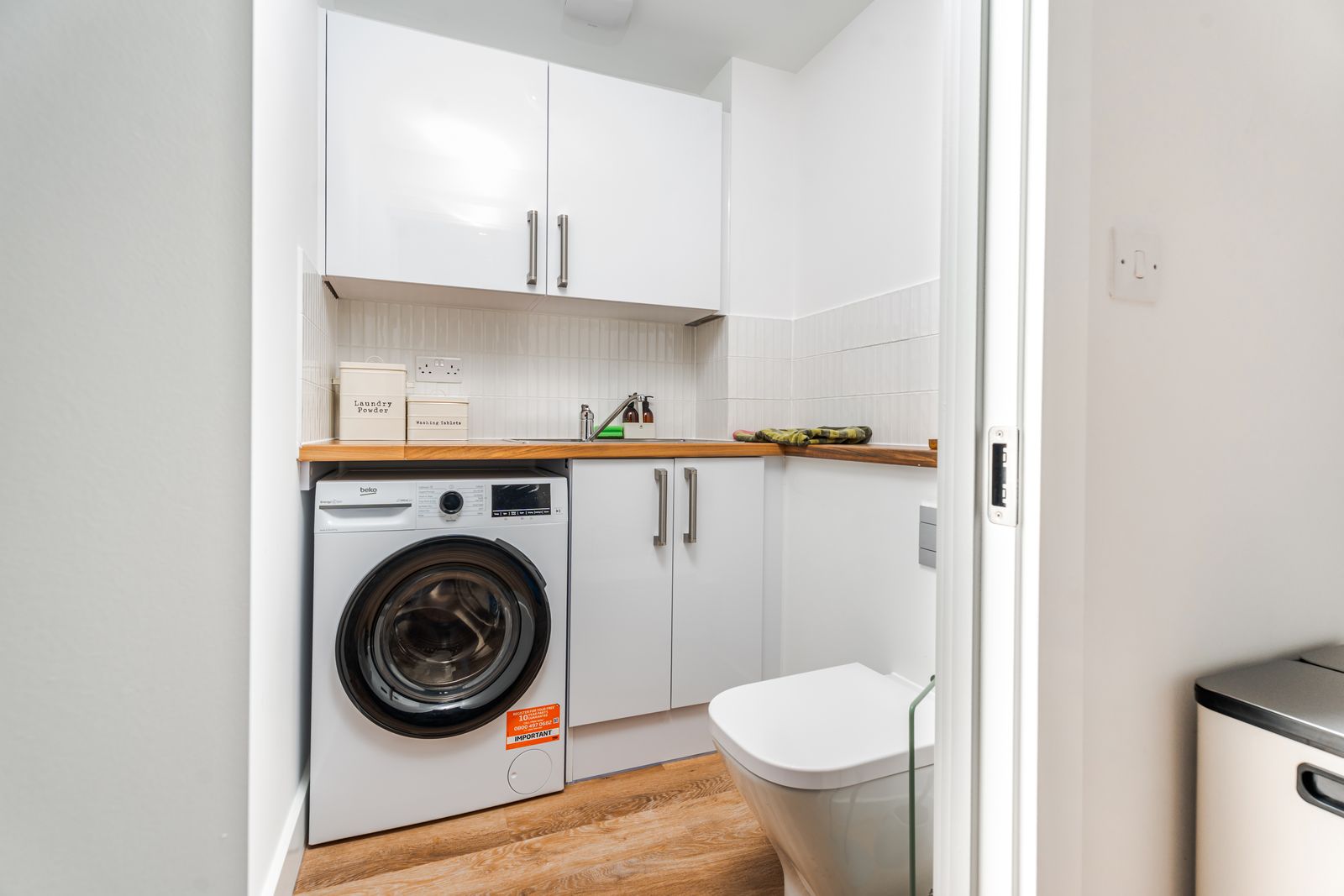 Utility room with washing machine and storage
