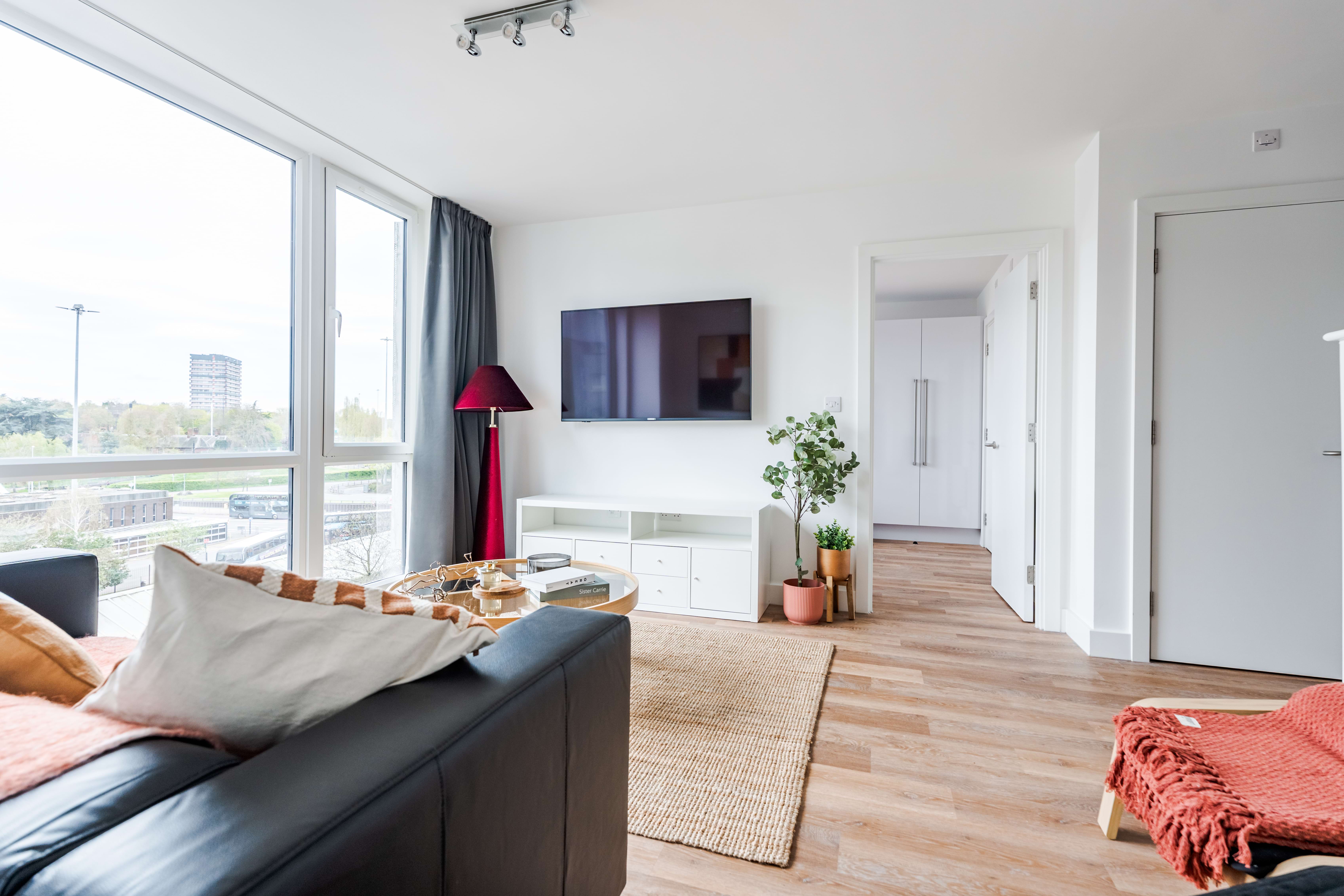 Living room with TV and floor-to-ceiling windows