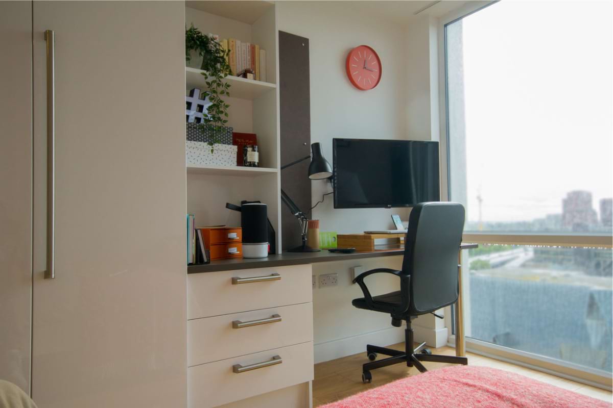 Deluxe Studio study area with office chair and floor to ceiling windows