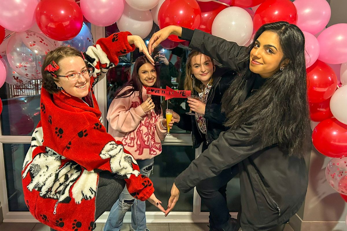 4 girls making a heart celebrating Valentines Day with CODE