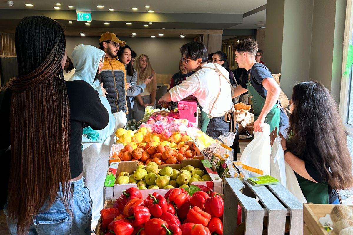 staff helping girl get her free fruit