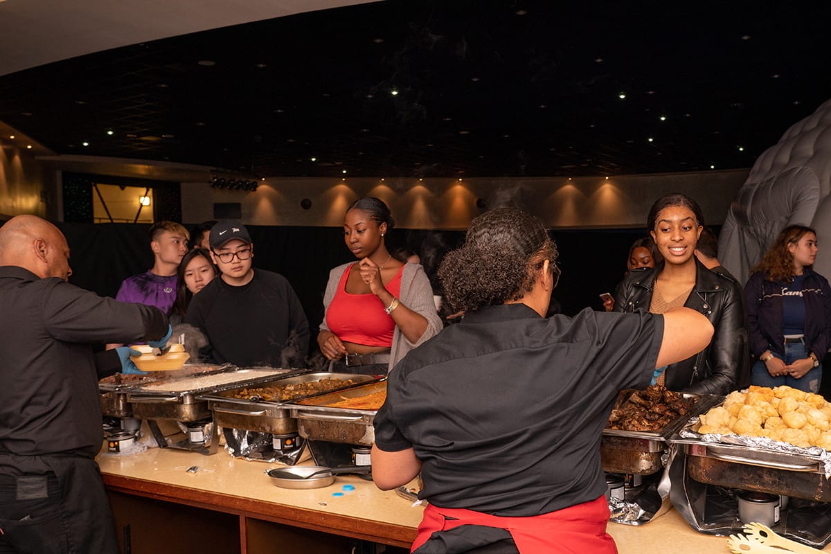 Serving Carribean food at CODE Student Accommodation Coventry Welcome Party