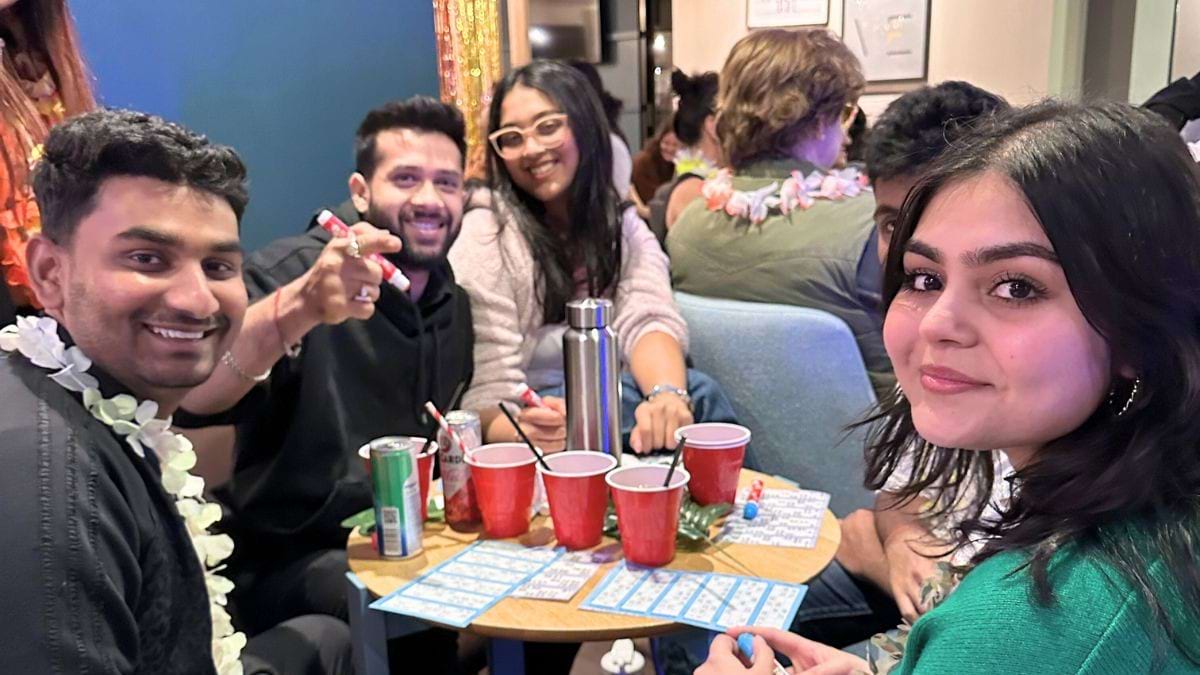 Friends playing bingo together at the tropical bingo event at CODE