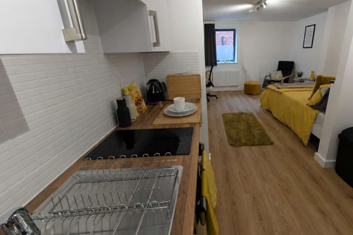 Image of a gold large city studio with a smaller window with privacy glass.