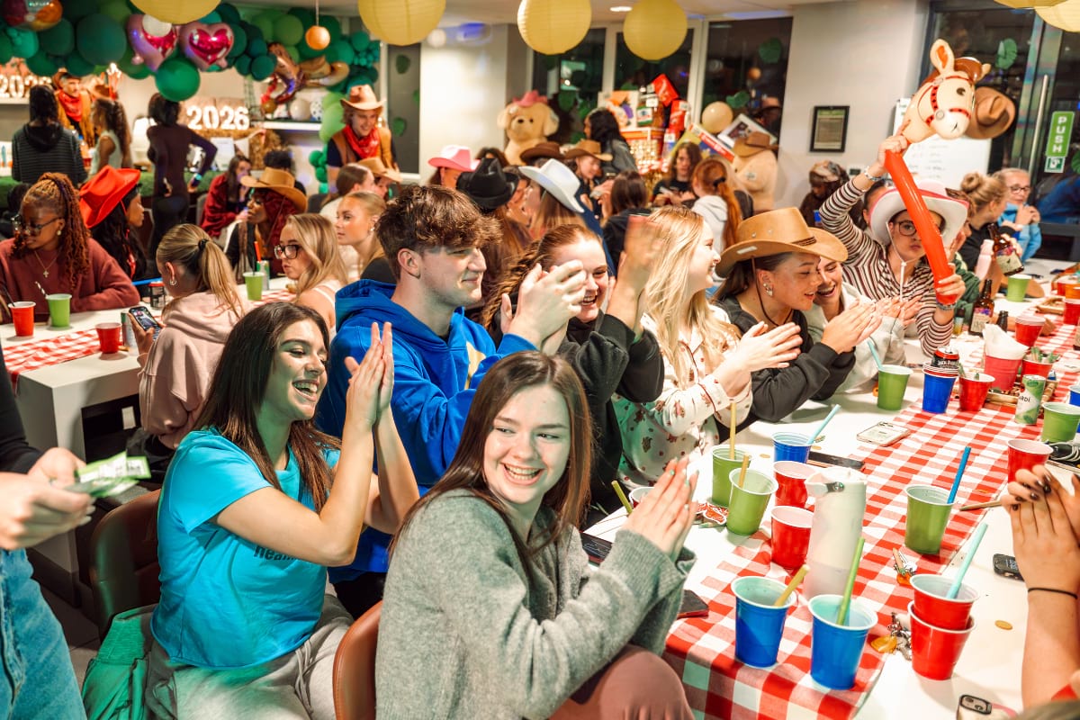 students sat around table smiling
